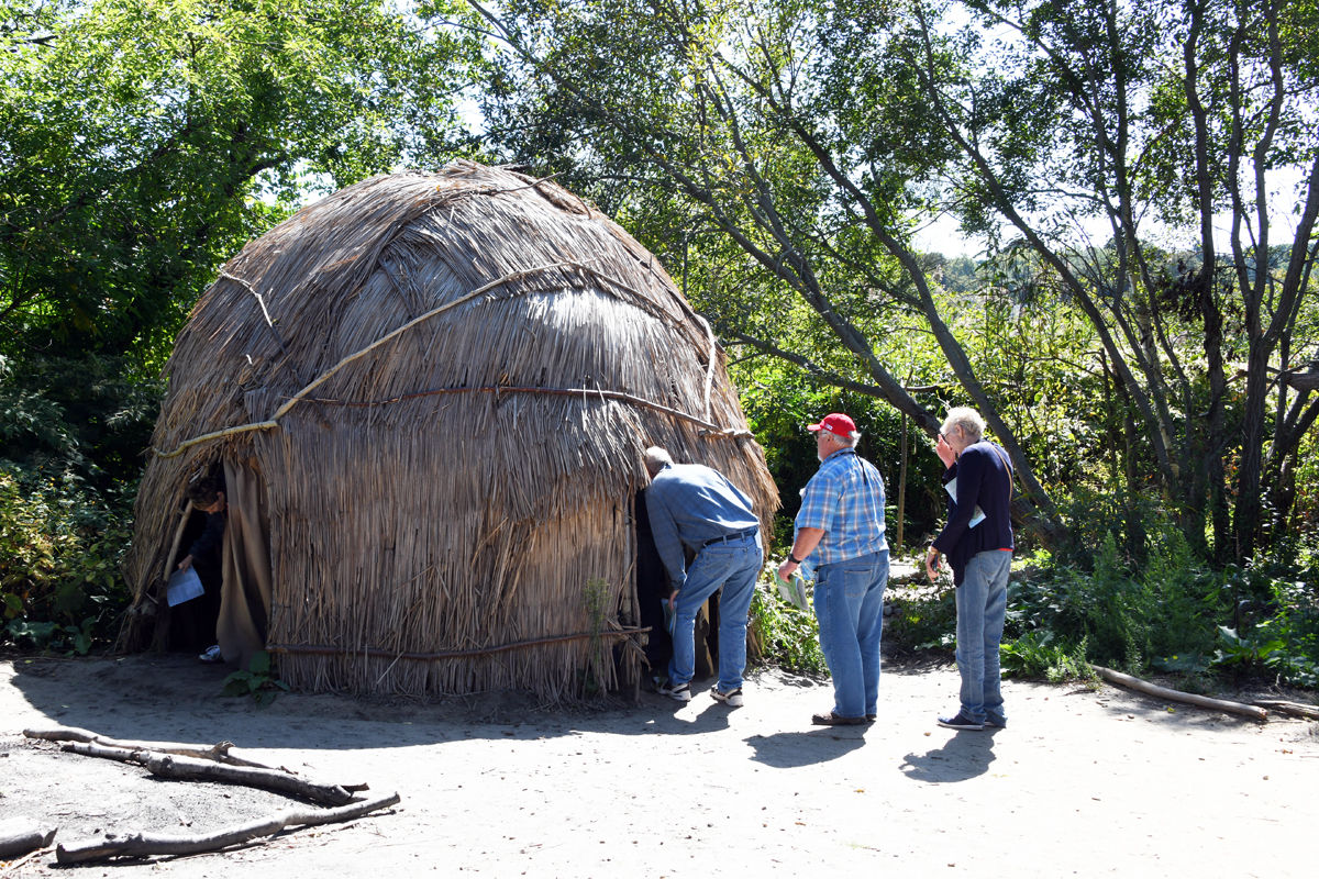 018 Althea Luethje emerges from Wampanoag hut as Gerald Kealiher, Karl Sherman and Kris Kealiher wait..jpg